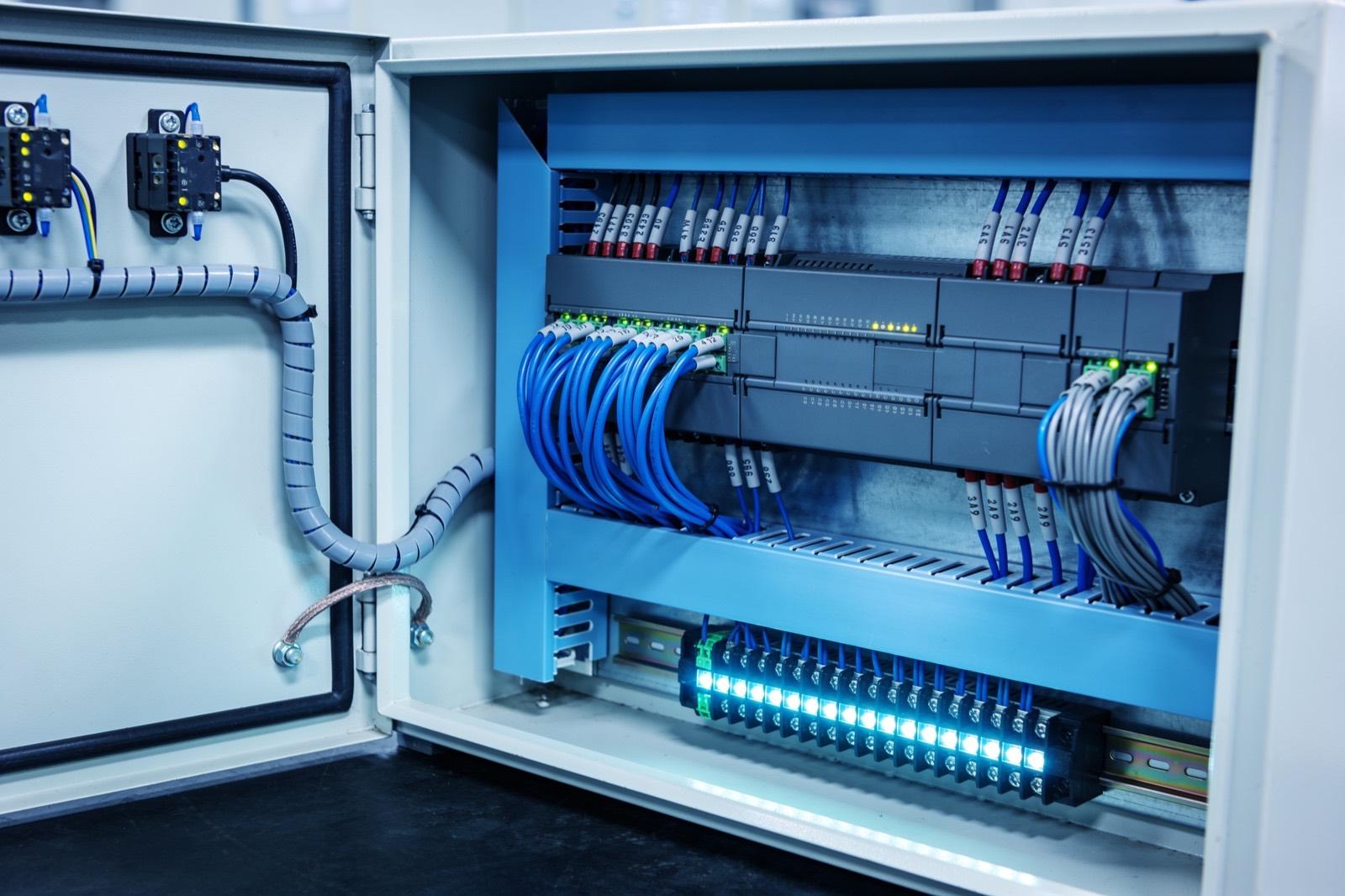 Illustrative: an industrial control cabinet with PLC modules and wiring
